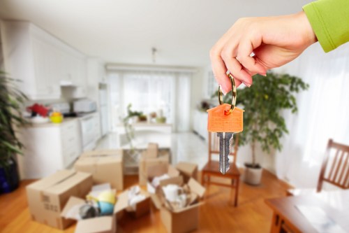 Professional movers carrying furniture through a Belgravia property