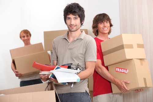 Professional movers handling boxed belongings in a Belgravia apartment