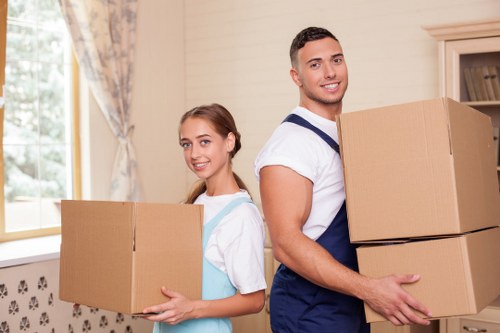 Professional movers transporting boxed household items