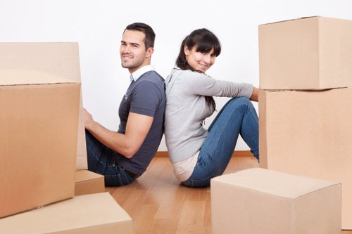 Professional mover loading boxes near elegant Belgravia homes