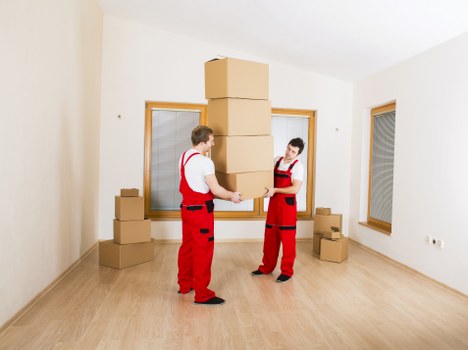 Business movers handling equipment near a central London office building