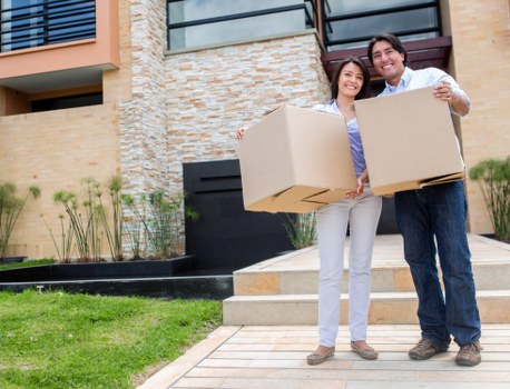 Removal crew handling boxed household items in central London